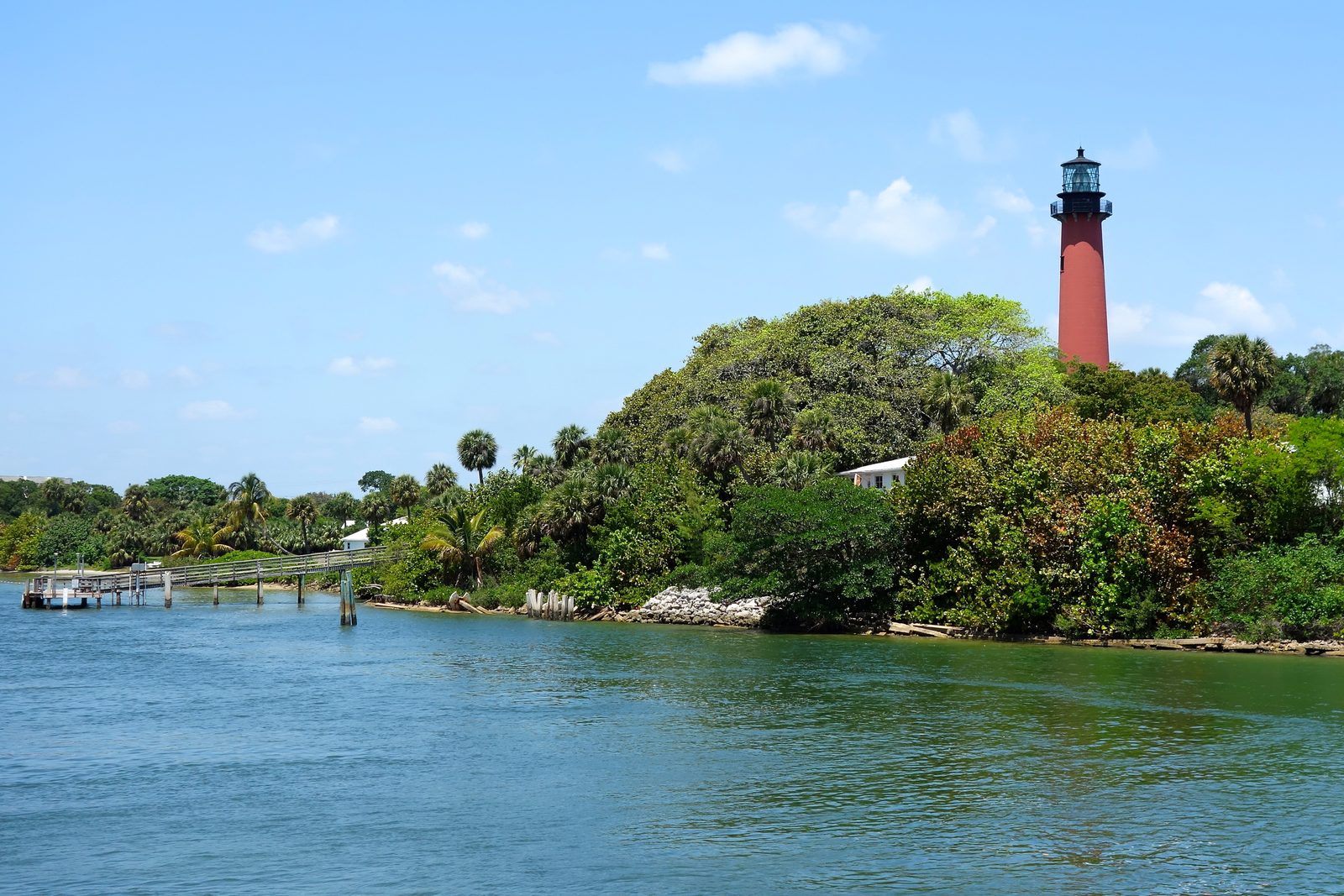 Jupiter Inlet Lighthouse on its green bluff above the waterfront in Jupiter, Florida